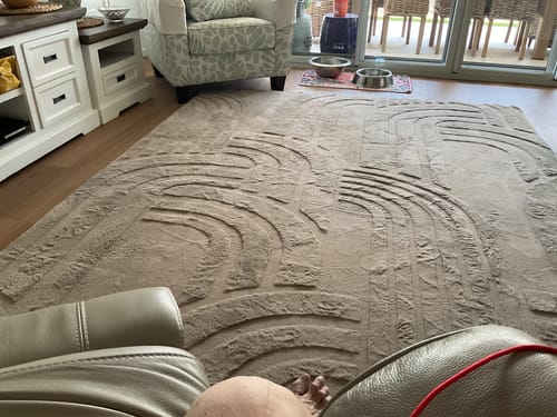 Customer's large mocha Mellow Mat with a carved 3D pattern laid out in their living room.
