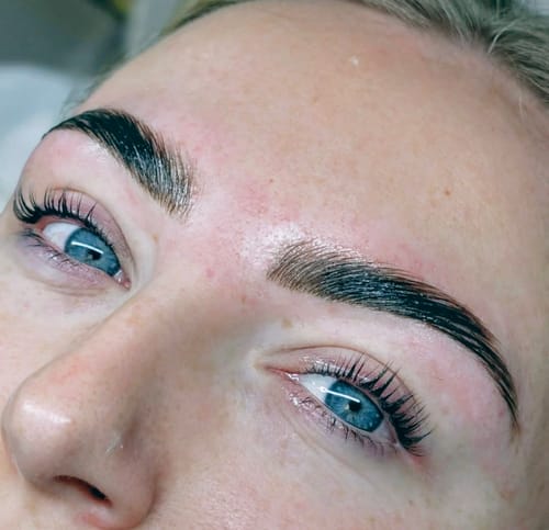 Reviewer's close-up of sleek brows after a Hybrid Stain and Eyebrow Lamination treatment.