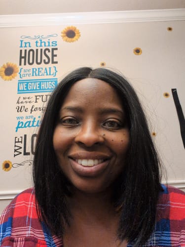 Reviewer smiling, showing the vibrant look of the Polar Light Yellow green contacts on their dark eyes.