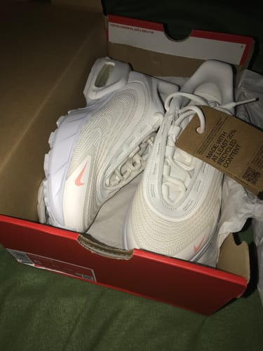 Customer's new white Nike Air Max Fire shoes with orange details, shown inside the original shoebox.
