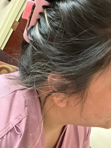 Close-up of a reviewer's thick hair pulled back securely with a pink cloud clip.