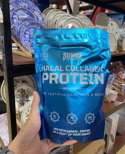 Reviewer holding the blue pouch of Halal Collagen Protein.