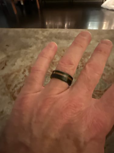 Customer's hand wearing the Black Barrel ring, showing the black band and wood inlay.