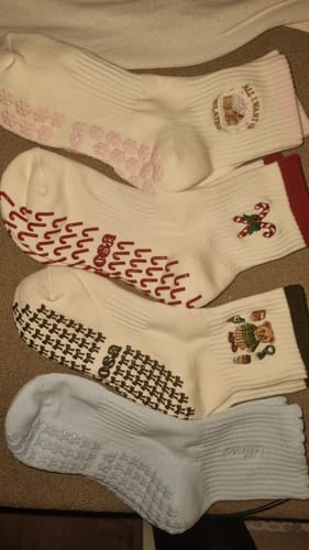 Customer's collection of four pairs of Candy Christmas non-slip socks with various festive designs.