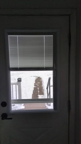 Customer's Raise & Lower Blinds Glass and Frame Kit installed in a door, with the blinds lowered halfway over the window.