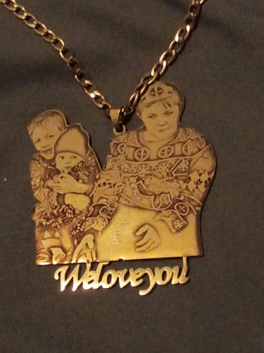 Customer's gold-tone Custom Photo Engraved Pendant Necklace with a picture of three children and the words 'Weloveyou!'.