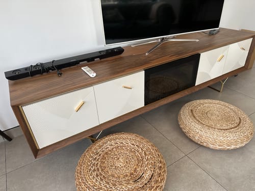 Customer's Pena TV Unit set up in a living room, showing the dark wood finish and white patterned doors.