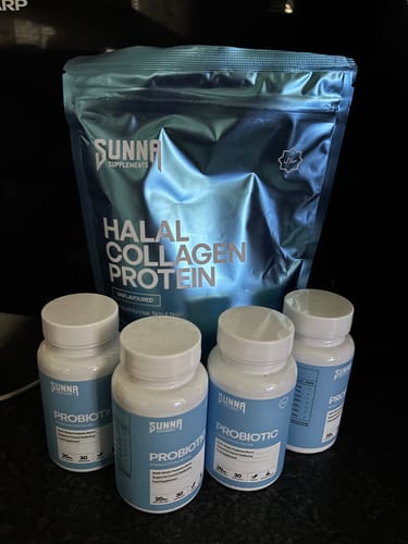 Customer's four white bottles of Probiotic supplements in front of a pouch of collagen protein.