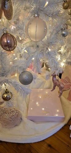 Customer's 2026 Essential Planner in its blush keepsake box, placed as a gift under a white Christmas tree.