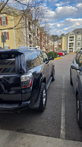 Customer's black 4Runner parked in a lot, showing the wider rear wheel stance after installing 1.25" Hubcentric Wheel Spacers.