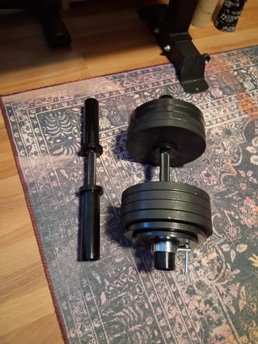 Customer's Olympic Screw Clamp Collar securing weights on a loadable dumbbell next to an empty dumbbell handle.