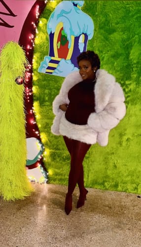 Reviewer wearing the white Faux Fur Pelted Mini Skirt with a matching jacket at a holiday event.