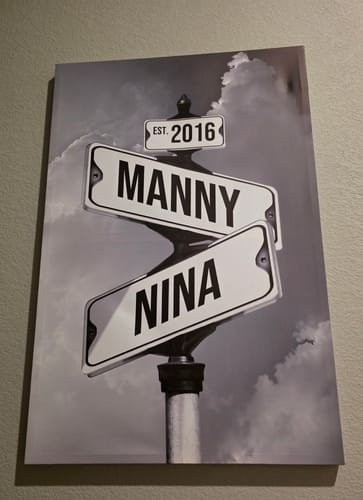 Customer's black and white 'COUPLES DATE OF LOVE' canvas showing street signs with the names 'Manny' and 'Nina' and 'EST. 2016'.