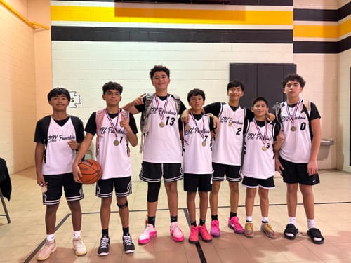 Customer's youth basketball team posing in their custom white and black basketball jerseys.