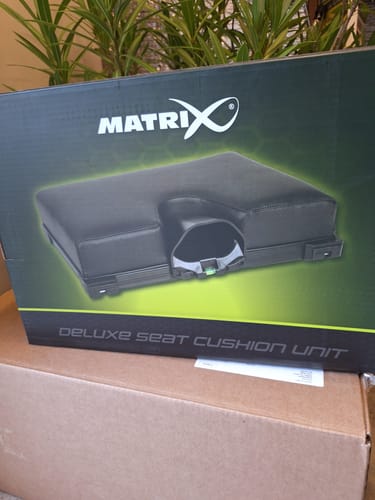 Klant toont de doos van de Matrix DELUXE SEAT CUSHION UNIT.