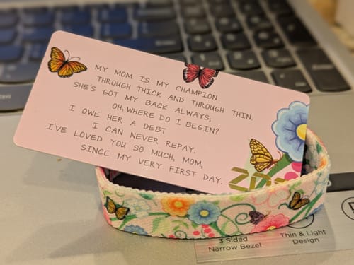 Reviewer's colorful floral I Love You Mom Bracelet, shown coiled with its accompanying poem card.