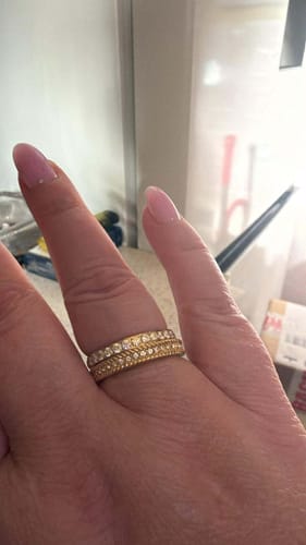 Customer's hand showing the Pavé Illusion Ring stacked with a similar band for a layered look.