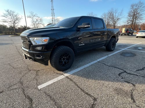 Customer's black Ram 1500 truck with a wider front stance after installing the 2-inch wheel spacers.