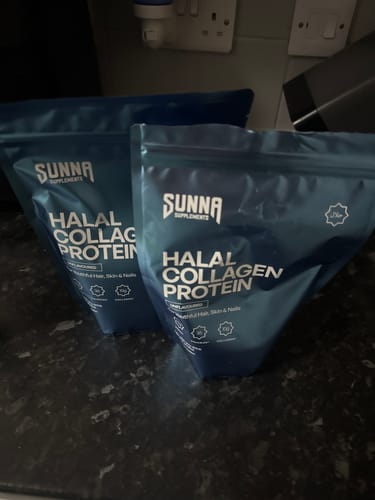 Customer's two blue pouches of Halal Collagen Protein from the Black Friday Bundle sitting on a dark kitchen counter.