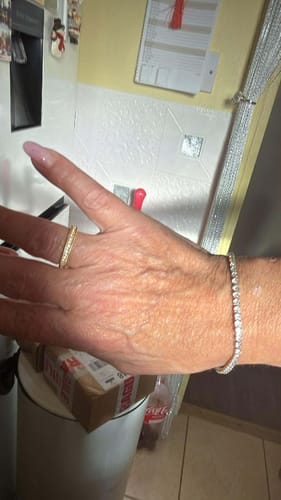 A reviewer's wrist adorned with the elegant, sparkling Tennis Bracelet.