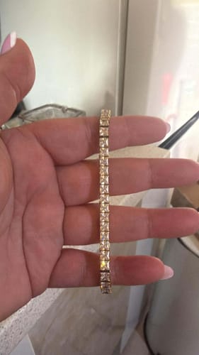 Reviewer holding the elegant Asscher Cut Bracelet in their hand, showing the sparkling stones.