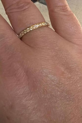 Close-up of a reviewer's hand wearing the sparkling Eternity Band Ring.