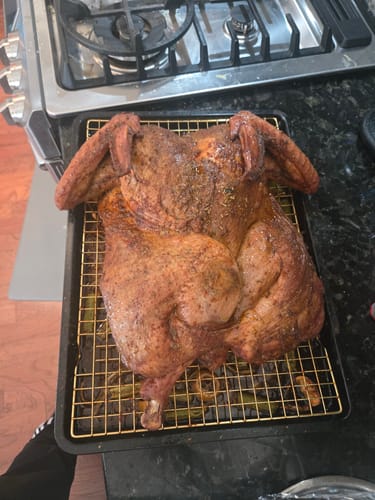 Customer's golden-brown spatchcocked turkey after cooking with the Turkey Brine Kit, shown on a wire rack.
