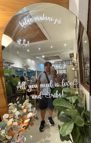 Reviewer wearing their black Nike Structure 26 Road Running Shoes while taking a full-length mirror selfie.