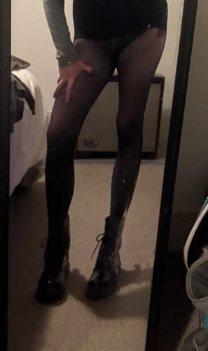 Customer's mirror selfie showing the sheer Free Hugging Seamless Tights worn with dark boots.