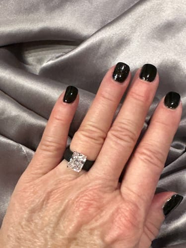 Reviewer's hand wearing the black Silicone Ring, showcasing its large, emerald-cut stone.