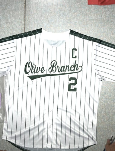 Customer's personalized white baseball jersey with green pinstripes. The front has 'Olive Branch' and the number 2.