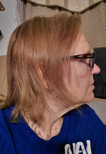 Reviewer shows their light brown hair color after using the Instant Dye Shampoo.