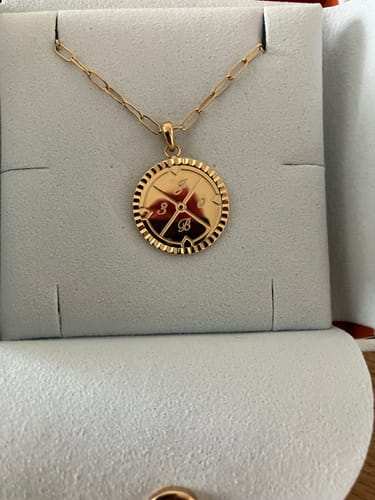 Reviewer's gold Engravable Compass Necklace in its presentation box, showing the custom engravings 'J', 'B', '3', and '0'.