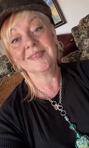 A close-up selfie of a smiling reviewer with clear, smooth skin for the Exfoliate product.