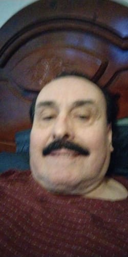 Close-up of a reviewer showing their dark hair and mustache after using the Instant Dye Shampoo.