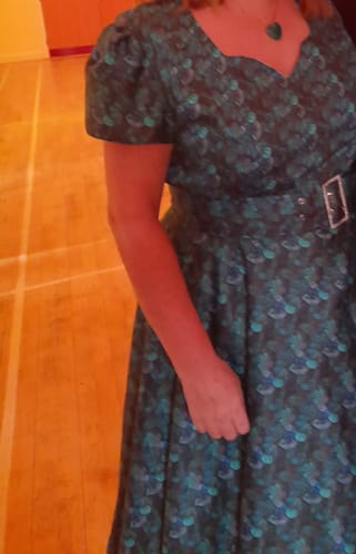 Customer showing a partial view of their 50s-style dress made from the Petals Paradise Cotton Satin Fabric.