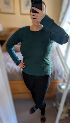 Reviewer showing the fit of the black Piper Pocket Tall leggings in a mirror selfie.