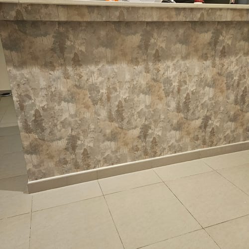 Reviewer's elegant Milas Wallpaper with a subtle tree pattern shown installed on a counter front.