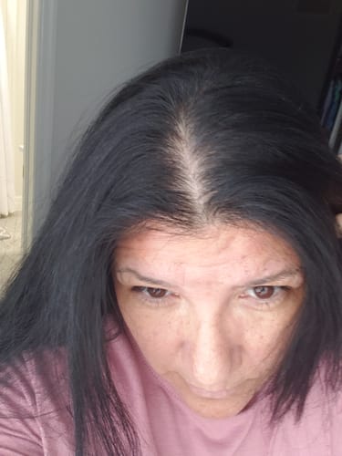 Customer showing dark hair with light roots along the part before using the Instant Dye Shampoo.