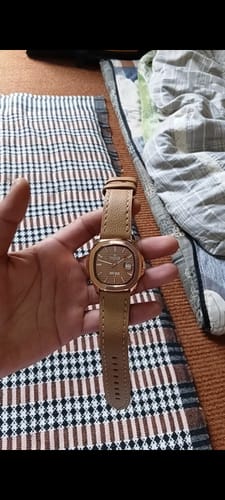 Reviewer holding the John Wick 3.0 watch with its camel leather strap and rose gold case.