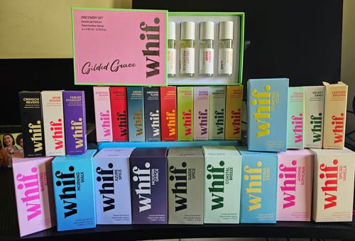 Reviewer's large collection of colorful Whif perfume boxes, including an open Discovery Set.