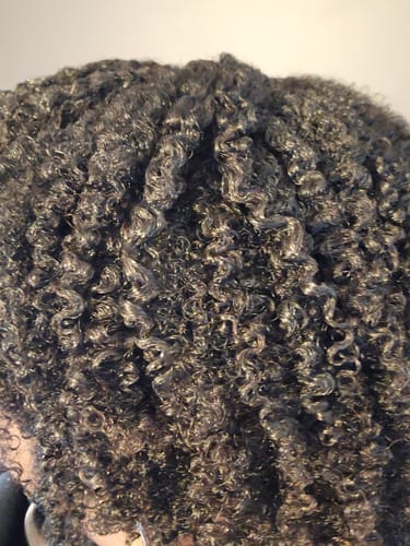 Close-up of a customer's defined, moisturized curls after using CLEANSED Moisturizing Shampoo.
