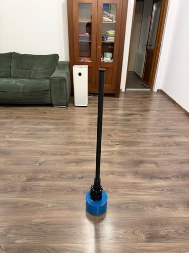 Customer's blue Olympic steel plate on a loading pin, pictured in a living room.