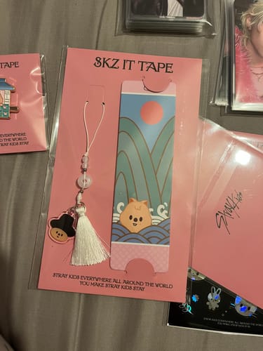 Customer's Stray Kids 'SKZ IT TAPE 'DO IT'' bookmark and tassel in its original pink packaging, laid on a flat surface.