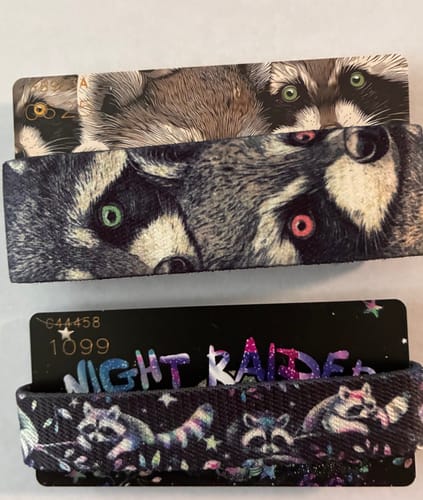 Customer displays their 'After Hours' and 'Night Raider' bands from the Trash Pandas Collection, each with its matching collector card.
