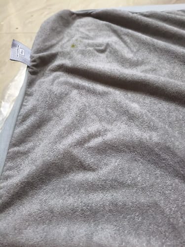 Close-up of the customer's soft grey cover for the Flo Adjustable Pillow, showing the fabric texture.