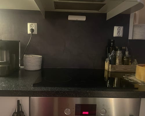 Kundens skifer antrasitt selvklebende fliser montert som en stilig bakvegg på et kjøkken.