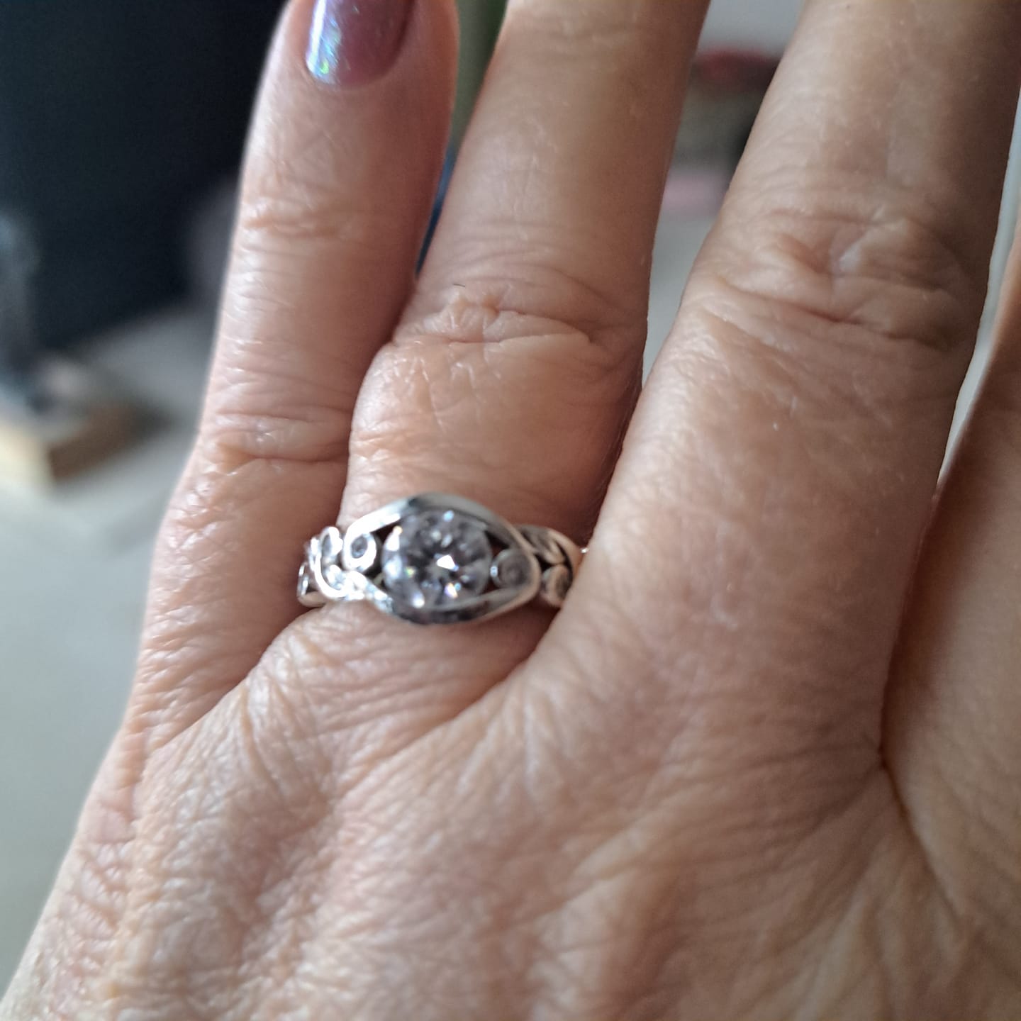 Customer photo review of Bezel Set Round Moissanite Scroll Accents Engagement Ring
