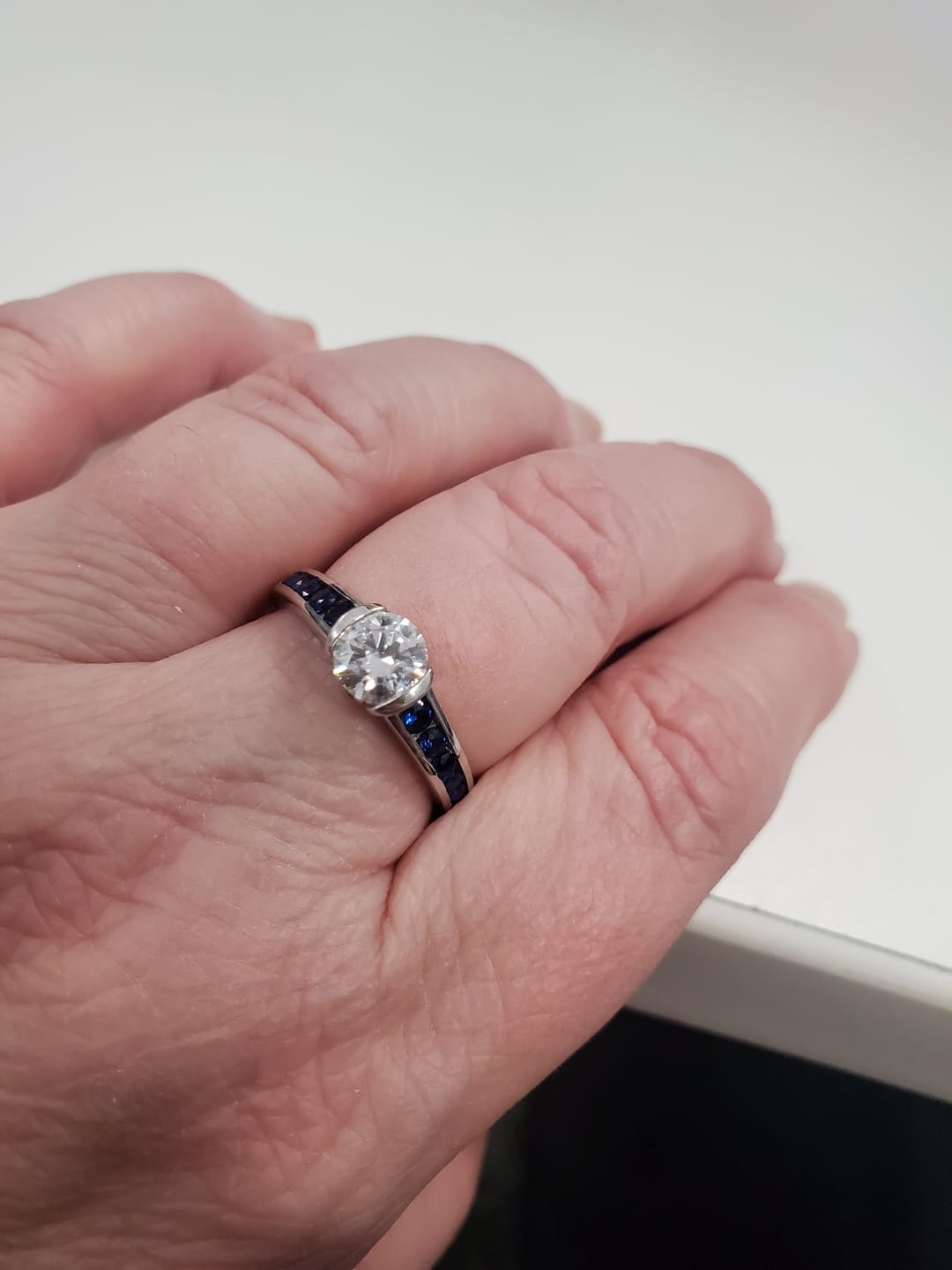 Customer photo review of Half Bezel Moissanite With Sapphire Channel Set Engagement Ring