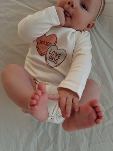 Customer photo review of long sleeve graphic bodysuit | candy hearts